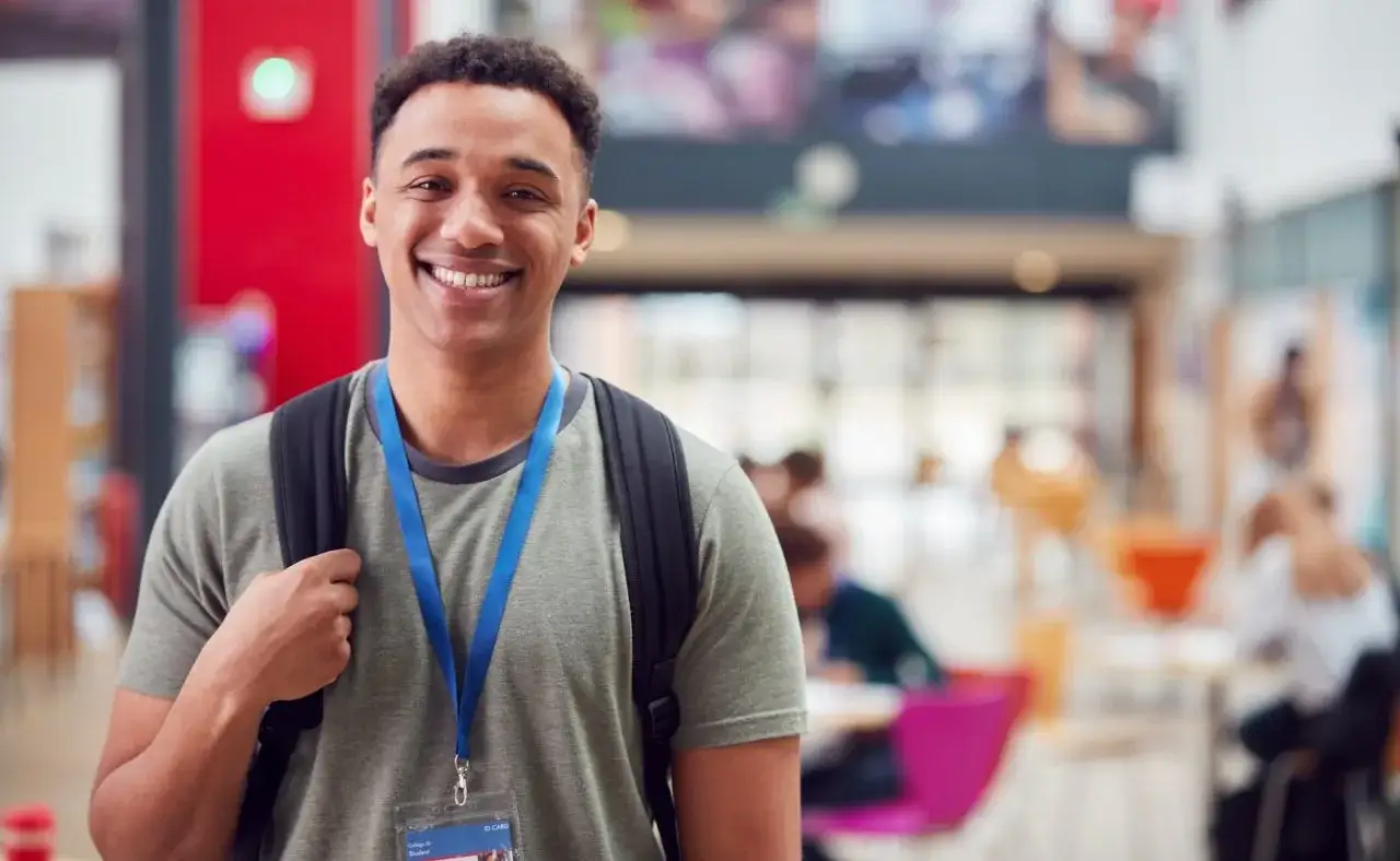 Smiling male student in a busy communal building at Southern Ferns Campus Sri Lanka